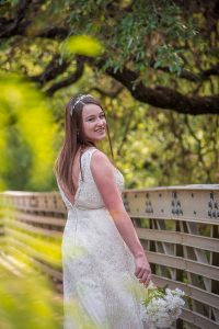 bride smiling on a bridge