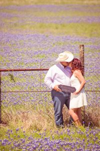 bride and groom in a bluebonnet field
