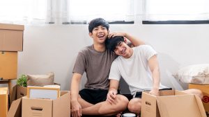 couple sitting in living room with empty boxes