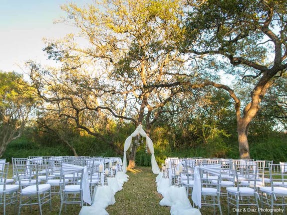 wedding ceremony at The Veranda with white chairs and white arbor