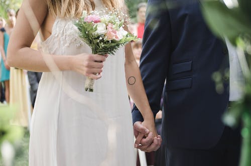 bride and groom holding hands at the altar