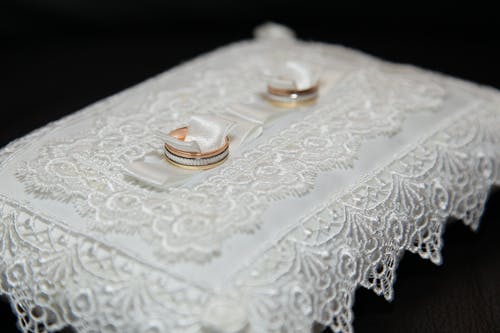 wedding rings on a white pillow