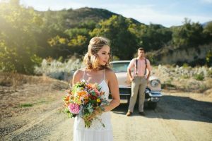 bride with bouquet looking back at groom