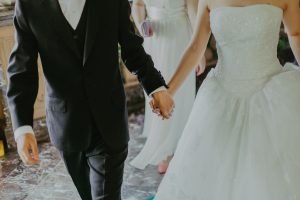 close up of bride and groom holding hands